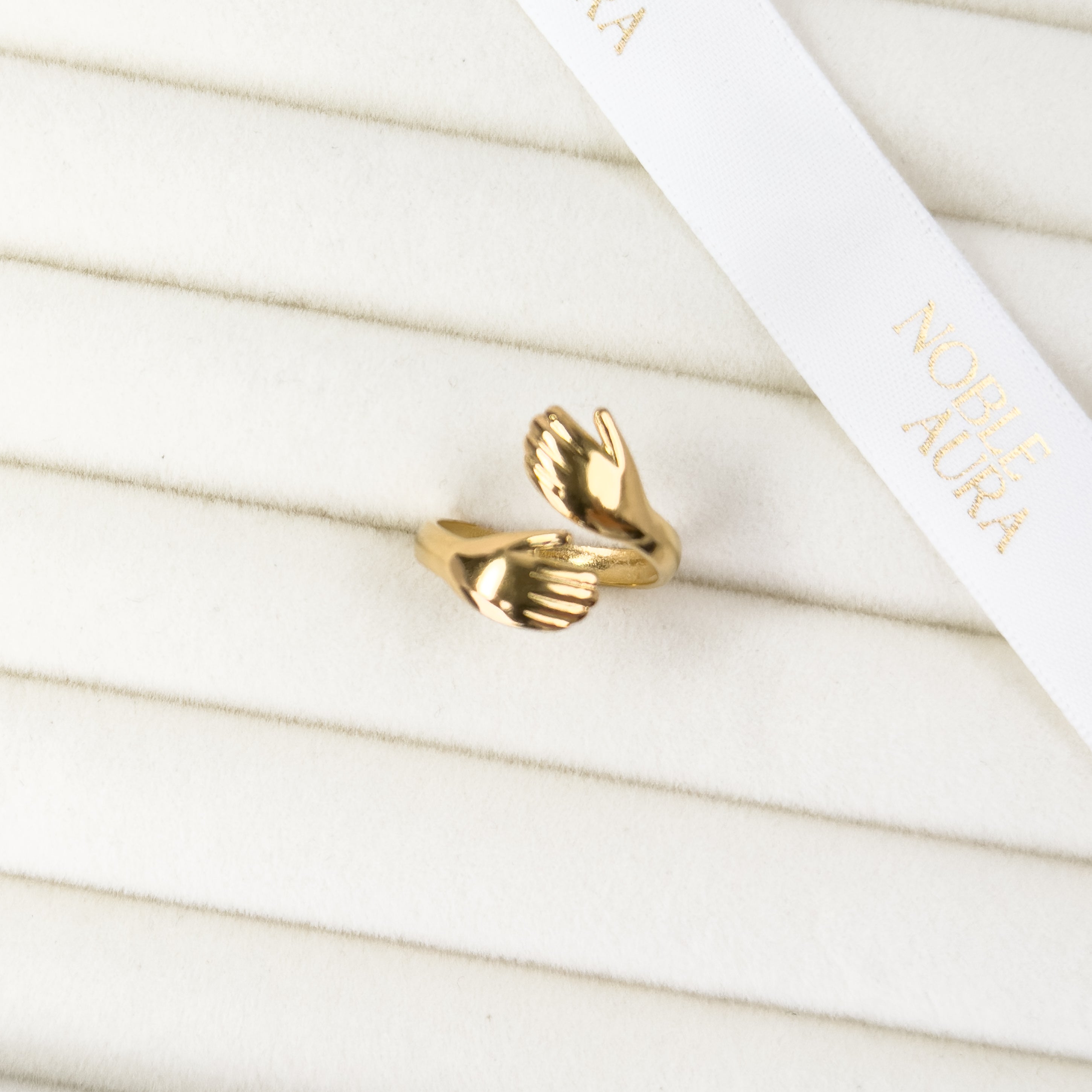 Gold angel hug adjustable ring with symbolic wrap design by Noble Aura UK