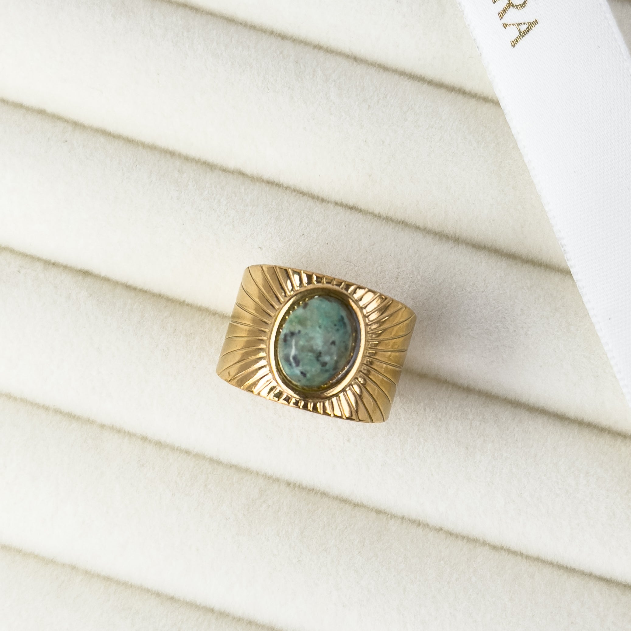 Gold statement ring featuring emerald green stone by Noble Aura UK