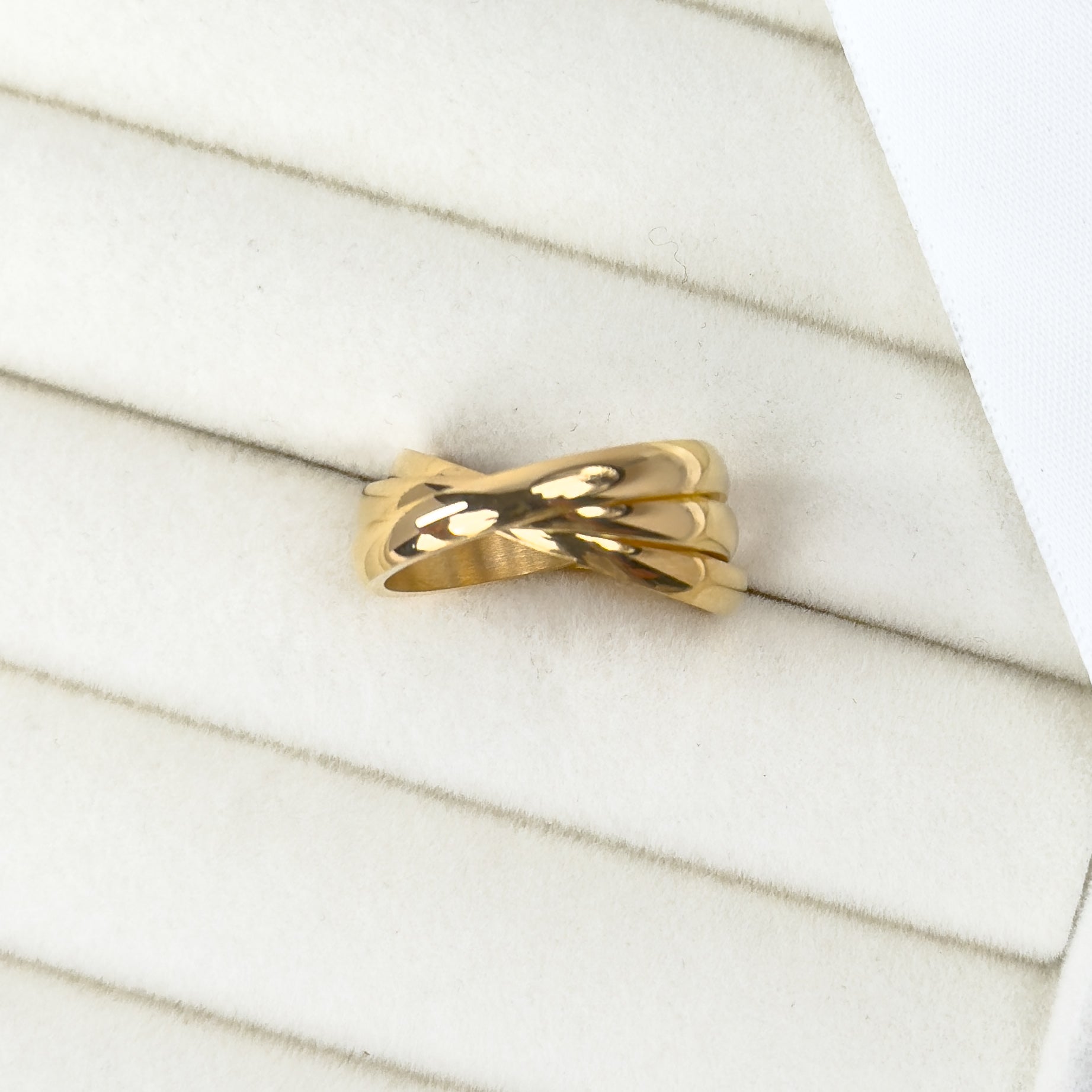 Gold trinity rolling ring with interlocking band design by Noble Aura UK