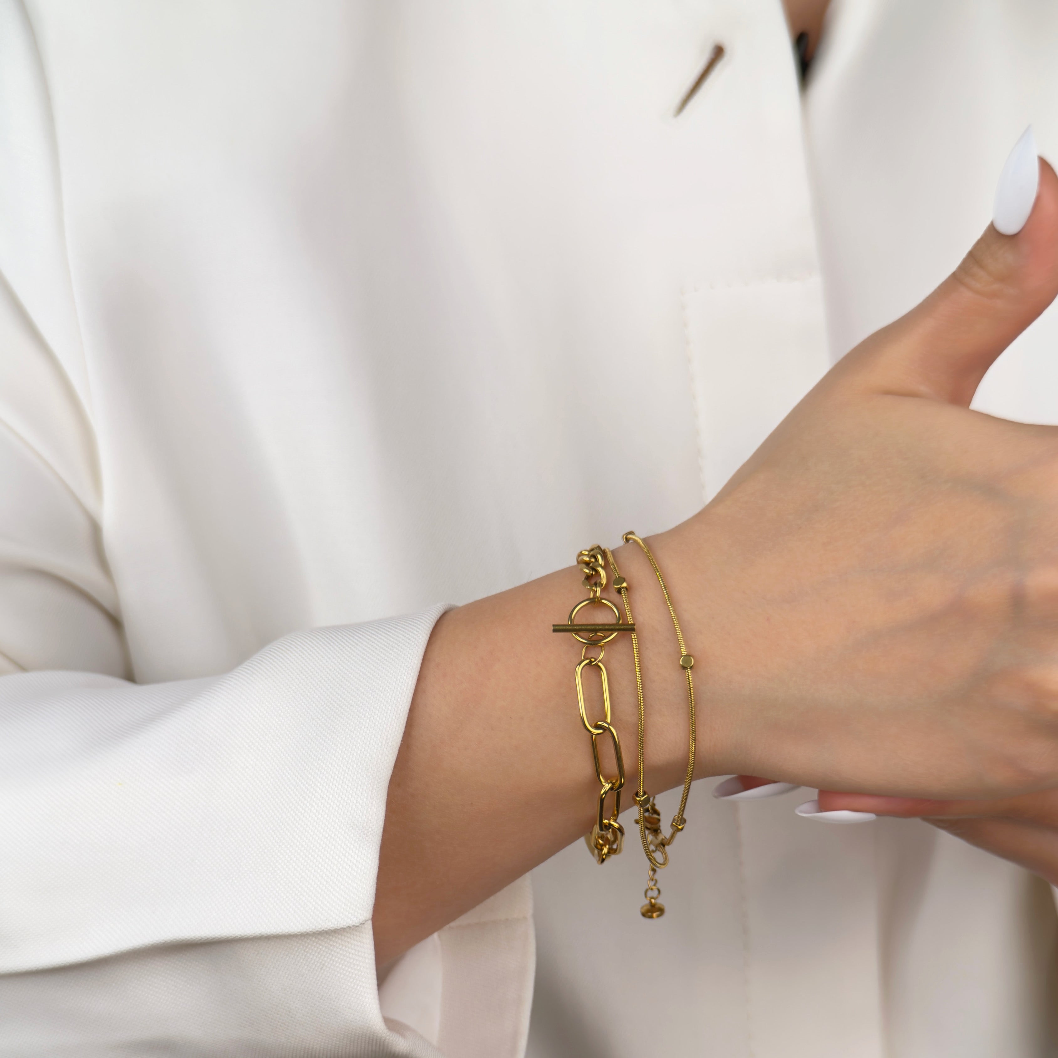 Minimalist gold snake chain bracelet for layering by Noble Aura Jewellery London, UK