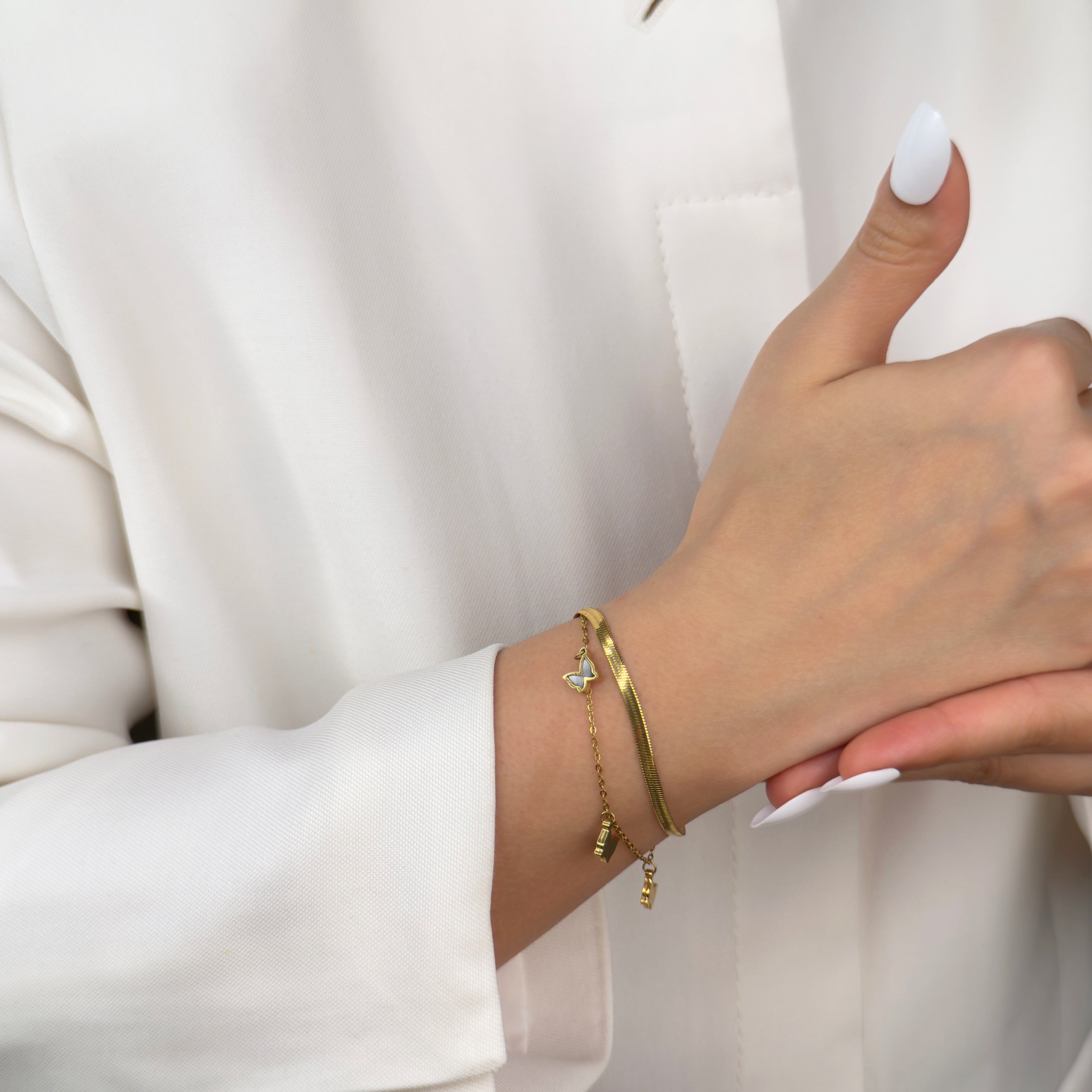 Gold butterfly charm bracelet with delicate chain by Noble Aura UK