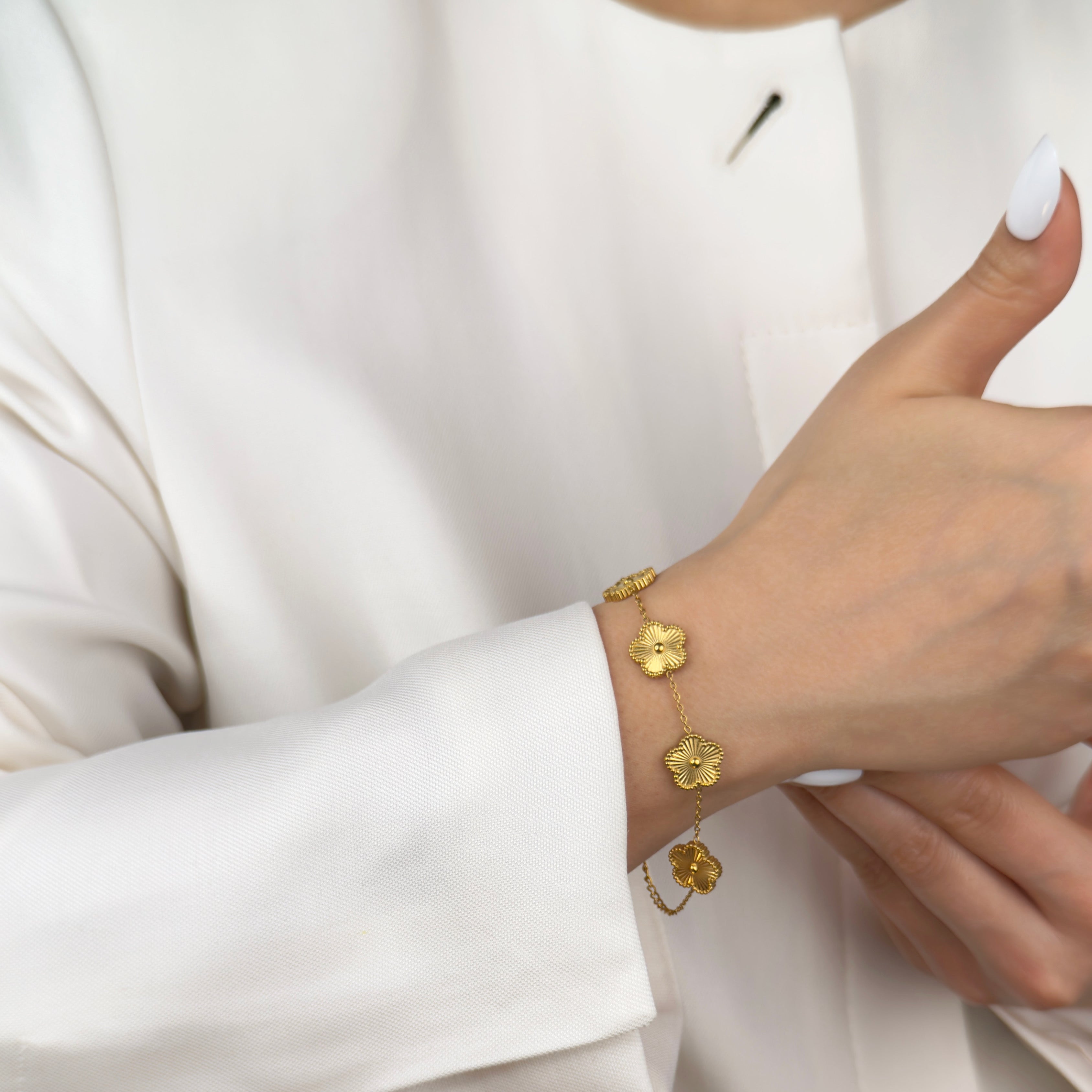 Gold floral charm bracelet with delicate detailing by Noble Aura UK