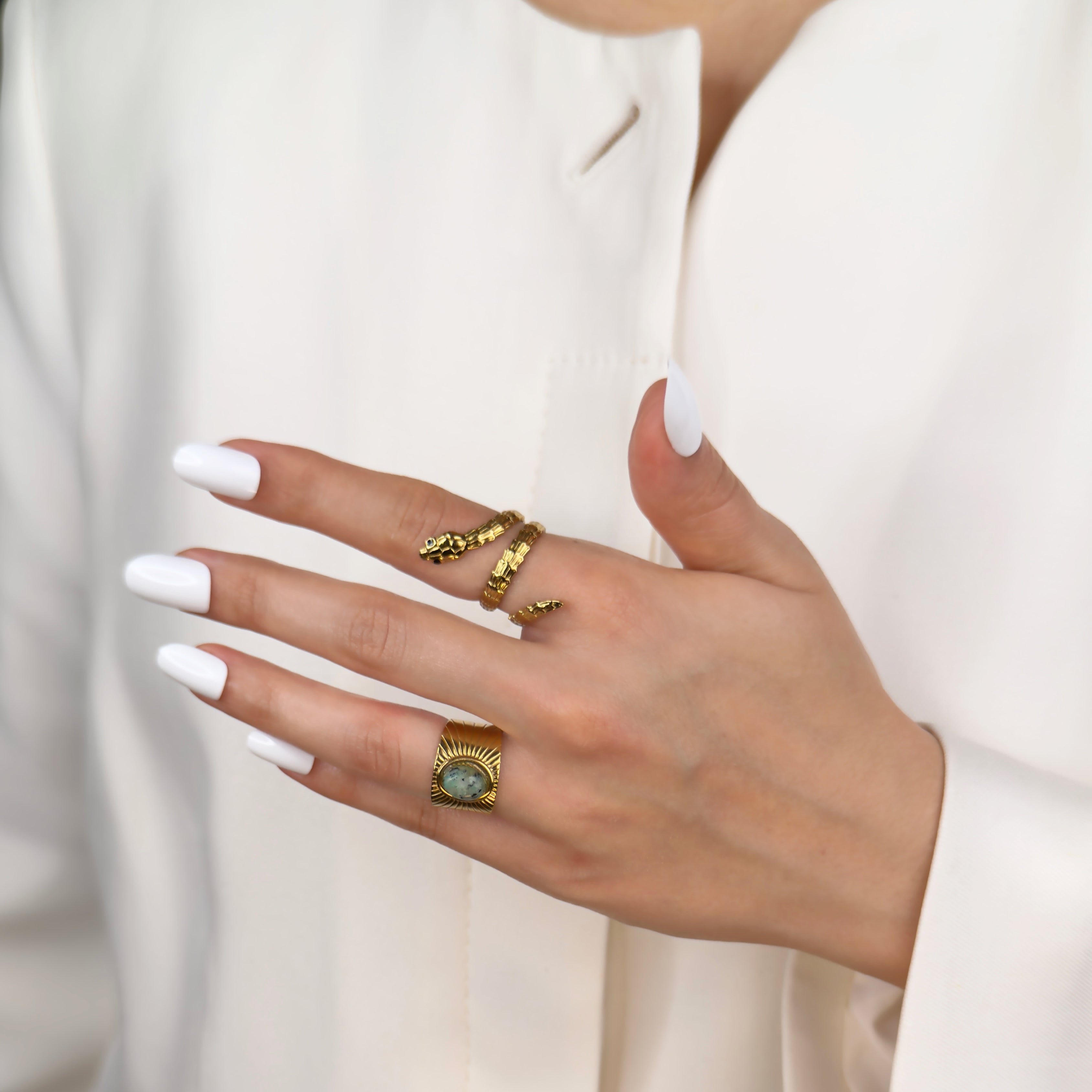 Gold statement ring featuring emerald green stone by Noble Aura UK