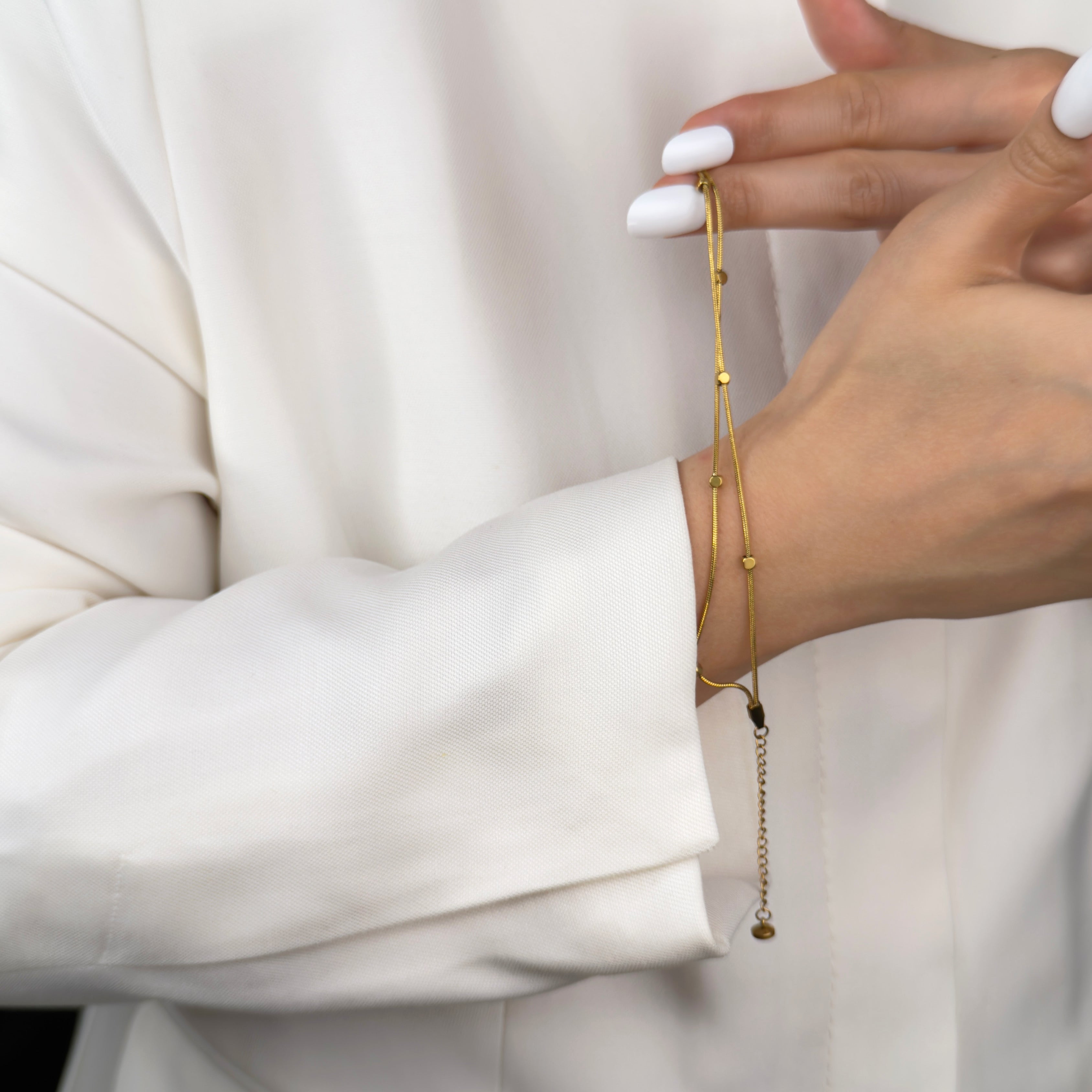 Minimalist gold snake chain bracelet for layering by Noble Aura Jewellery London, UK