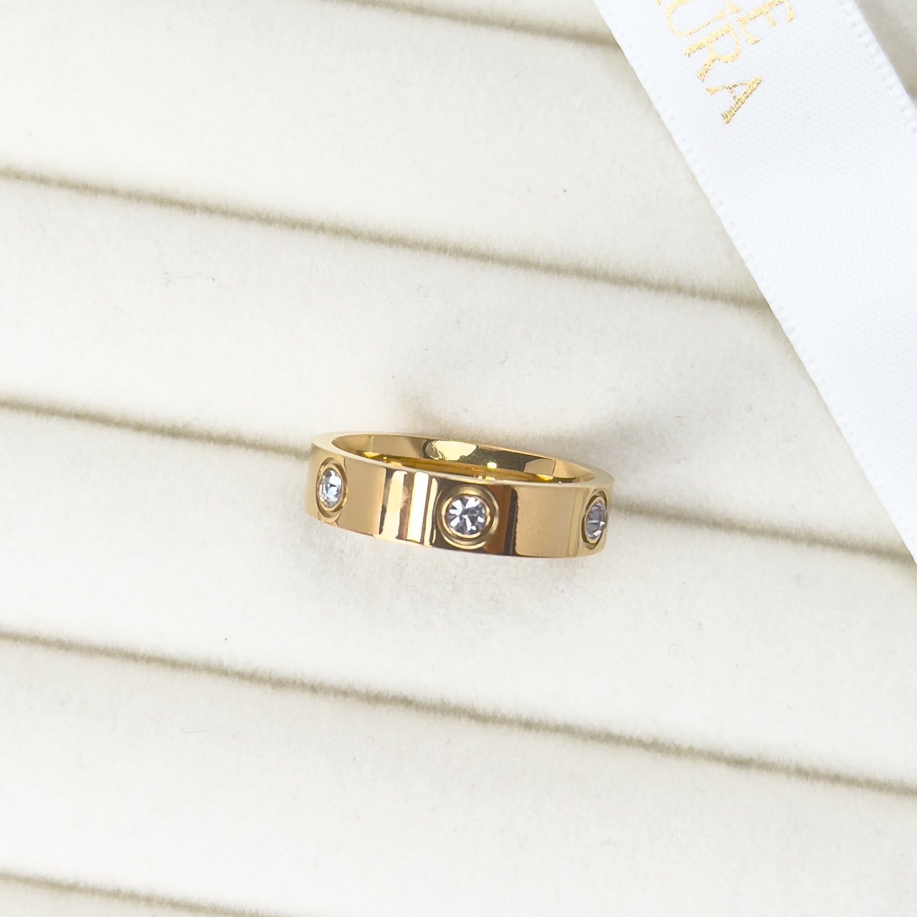 Gold bezel set band ring with minimalist stone setting by Noble Aura UK
