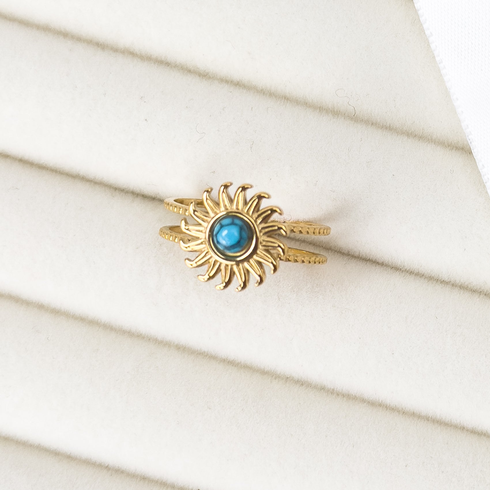 Gold cuff ring with turquoise sun design by Noble Aura UK
