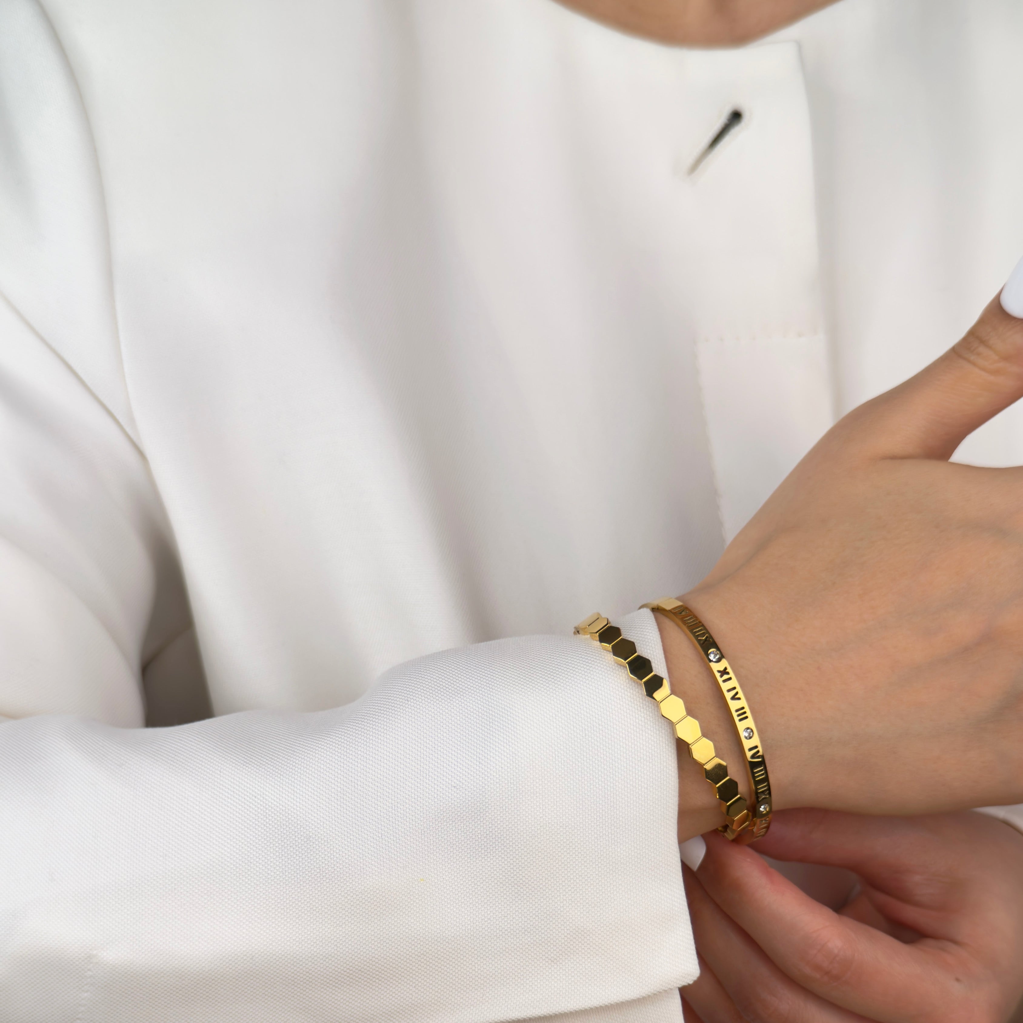 Gold Roman numeral diamond bangle and hexagon bangle bracelet by Noble Aura UK.
