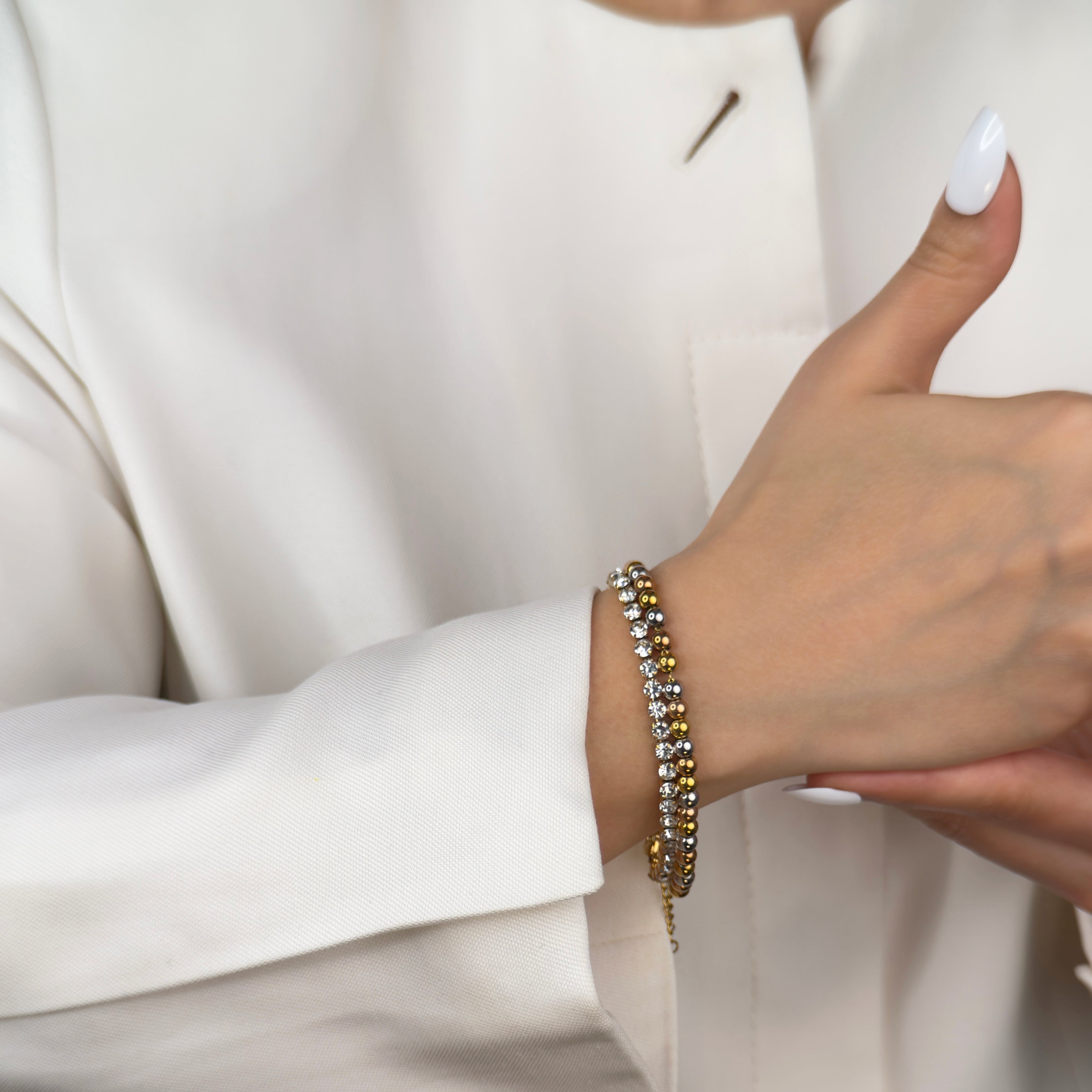 Minimalist gold tennis bracelet with sparkling stones by Noble Aura UK