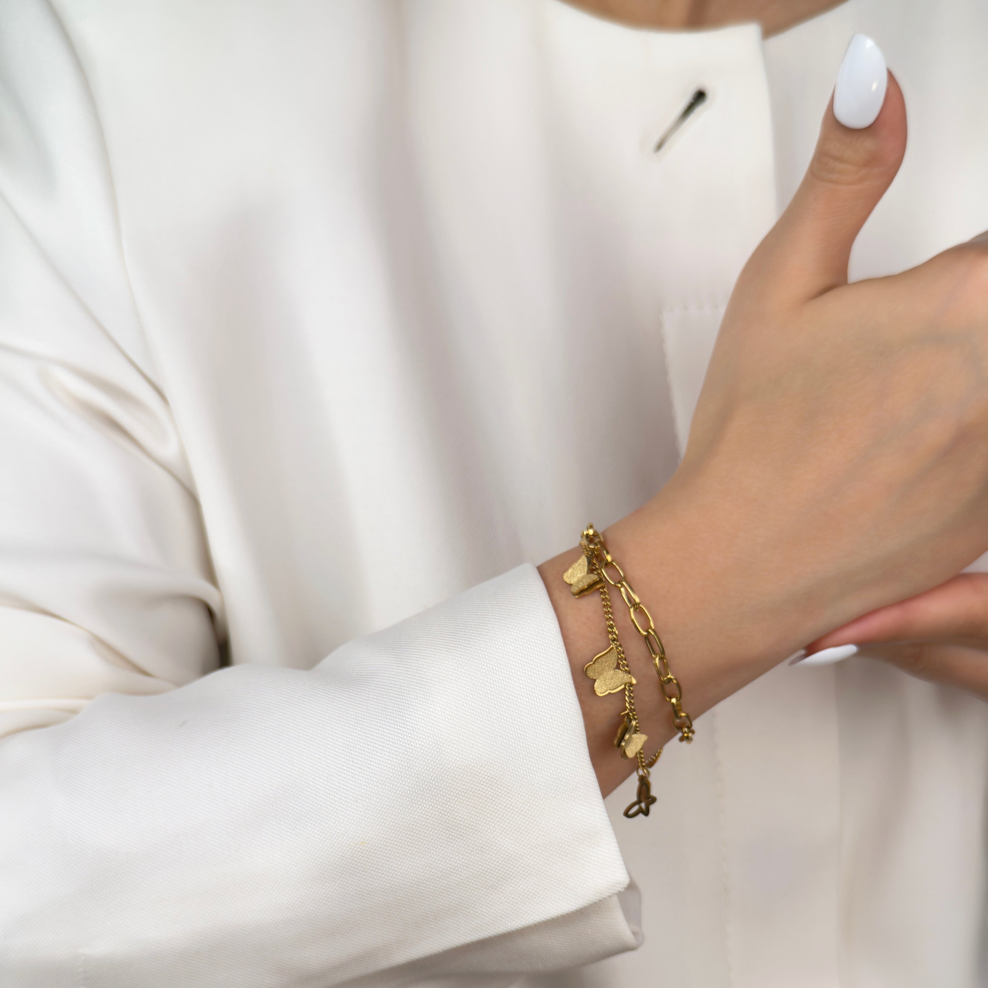 Gold butterfly charm bracelet with fine chain by Noble Aura UK
