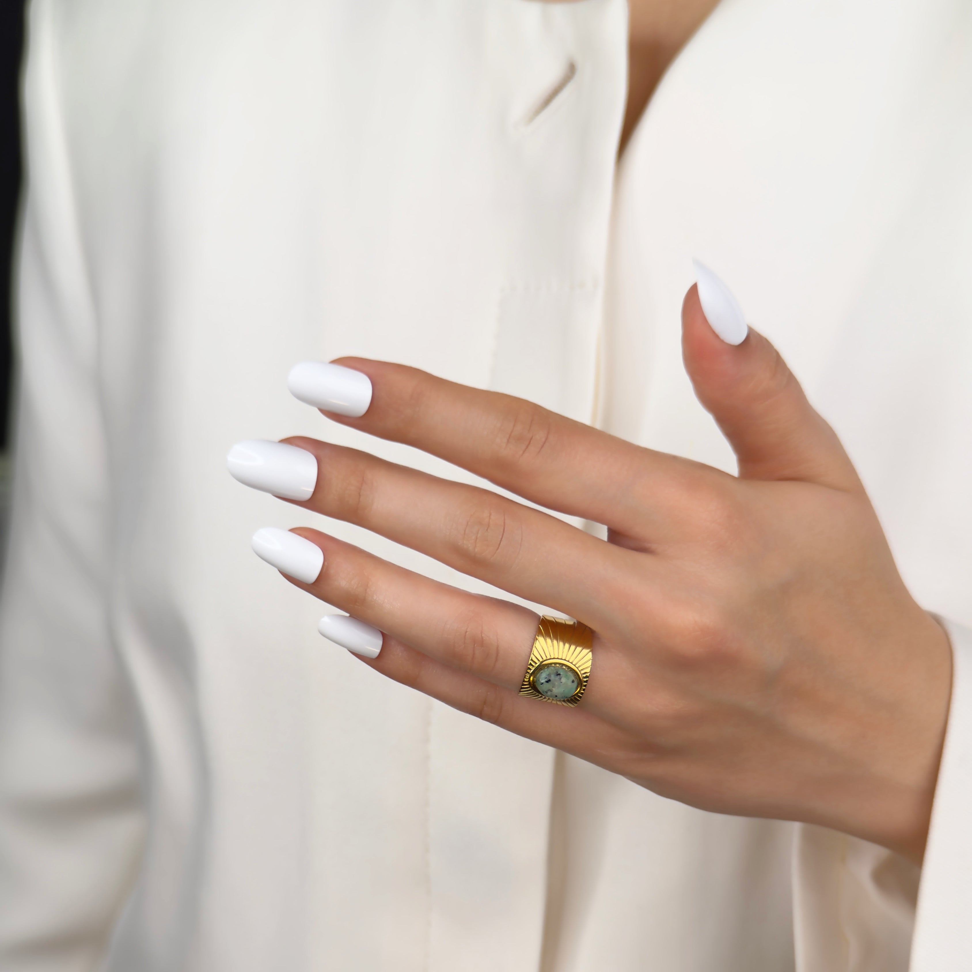 Gold statement ring featuring emerald green stone by Noble Aura UK
