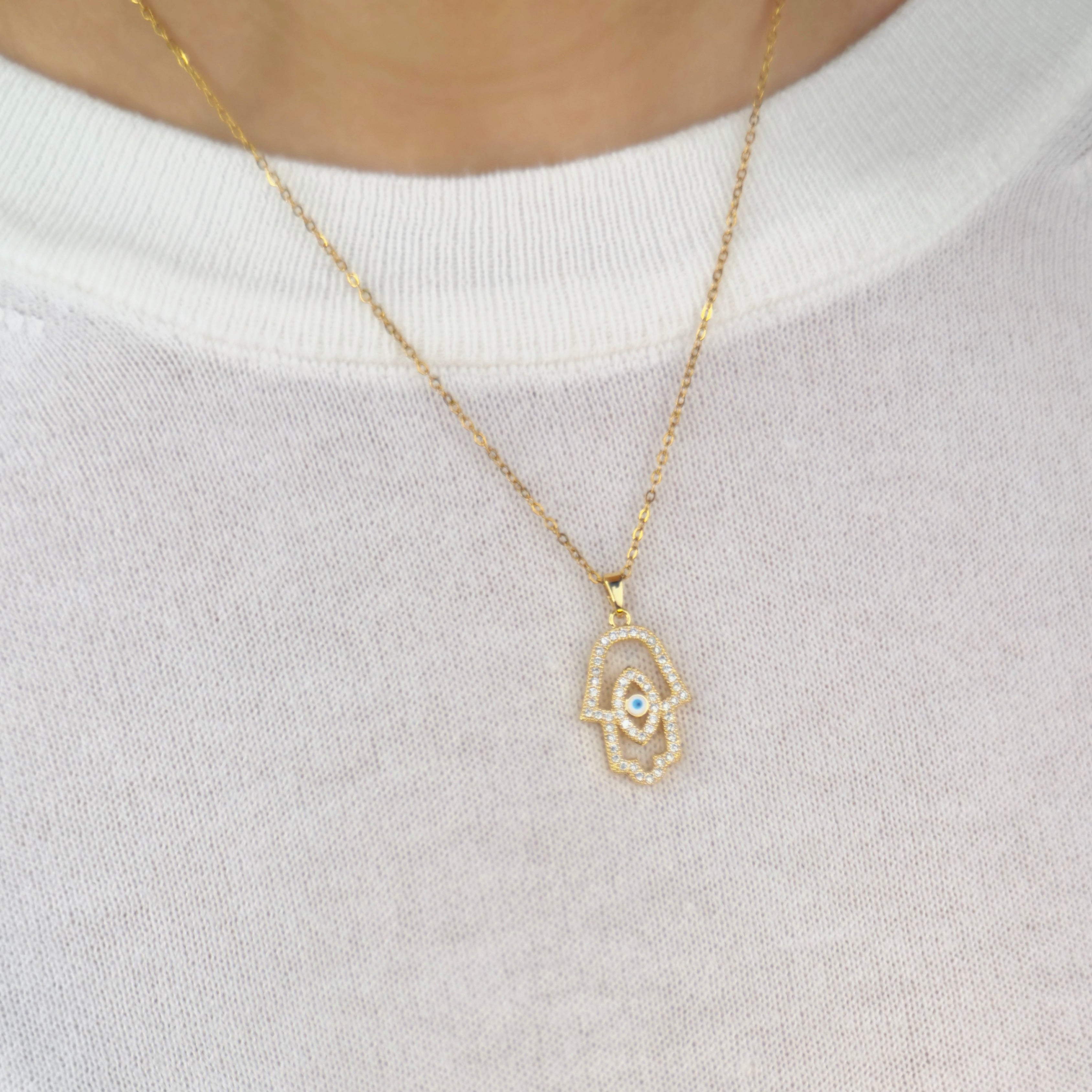 Gold Hamsa hand necklace with evil eye crystal pavé detailing by Noble Aura UK. Nazar Necklace. Comes in Premium packaging. Free Delivery over £50.