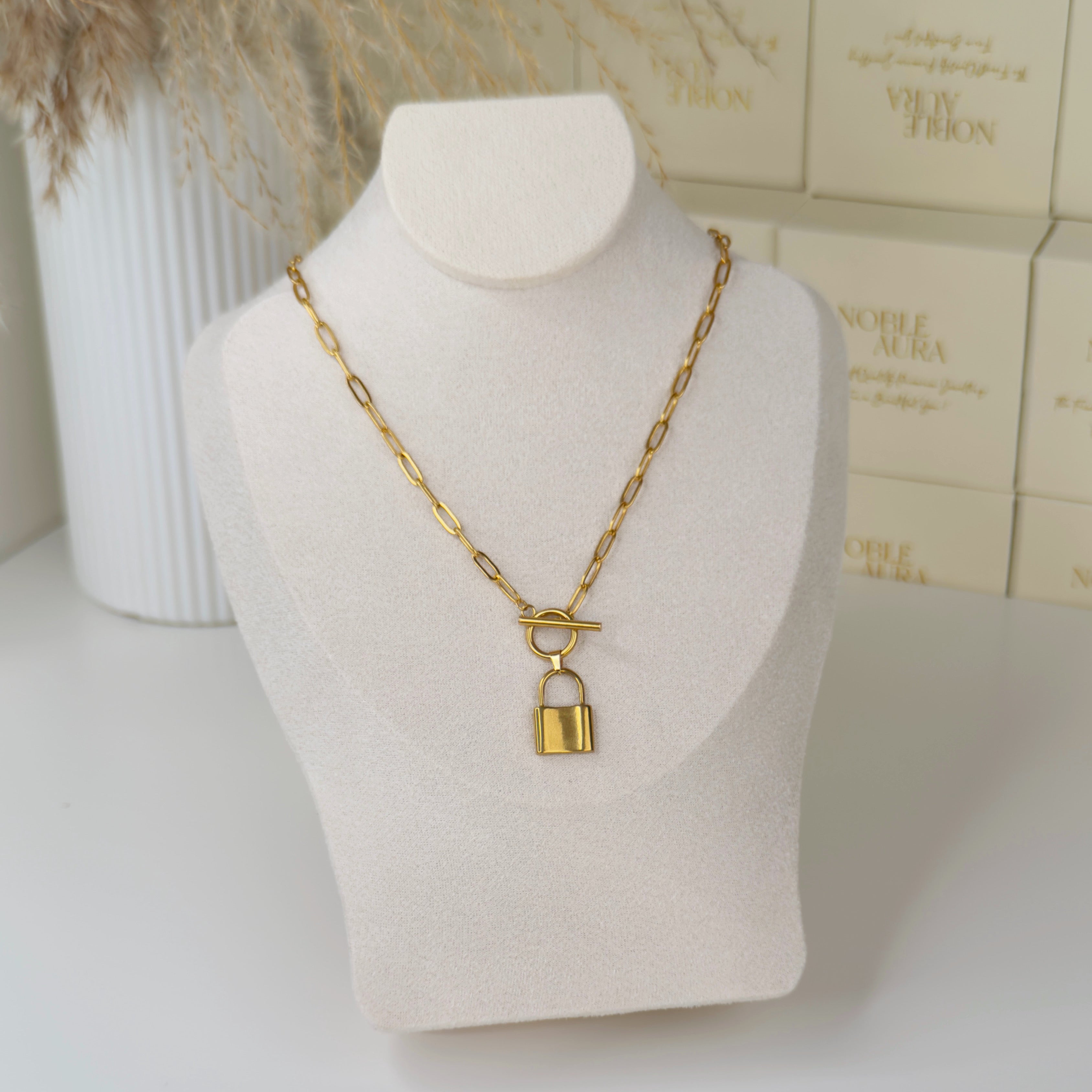 Gold padlock necklace with T bar fastening by Noble Aura UK. Comes in Premium packaging. Free Delivery over £50.
