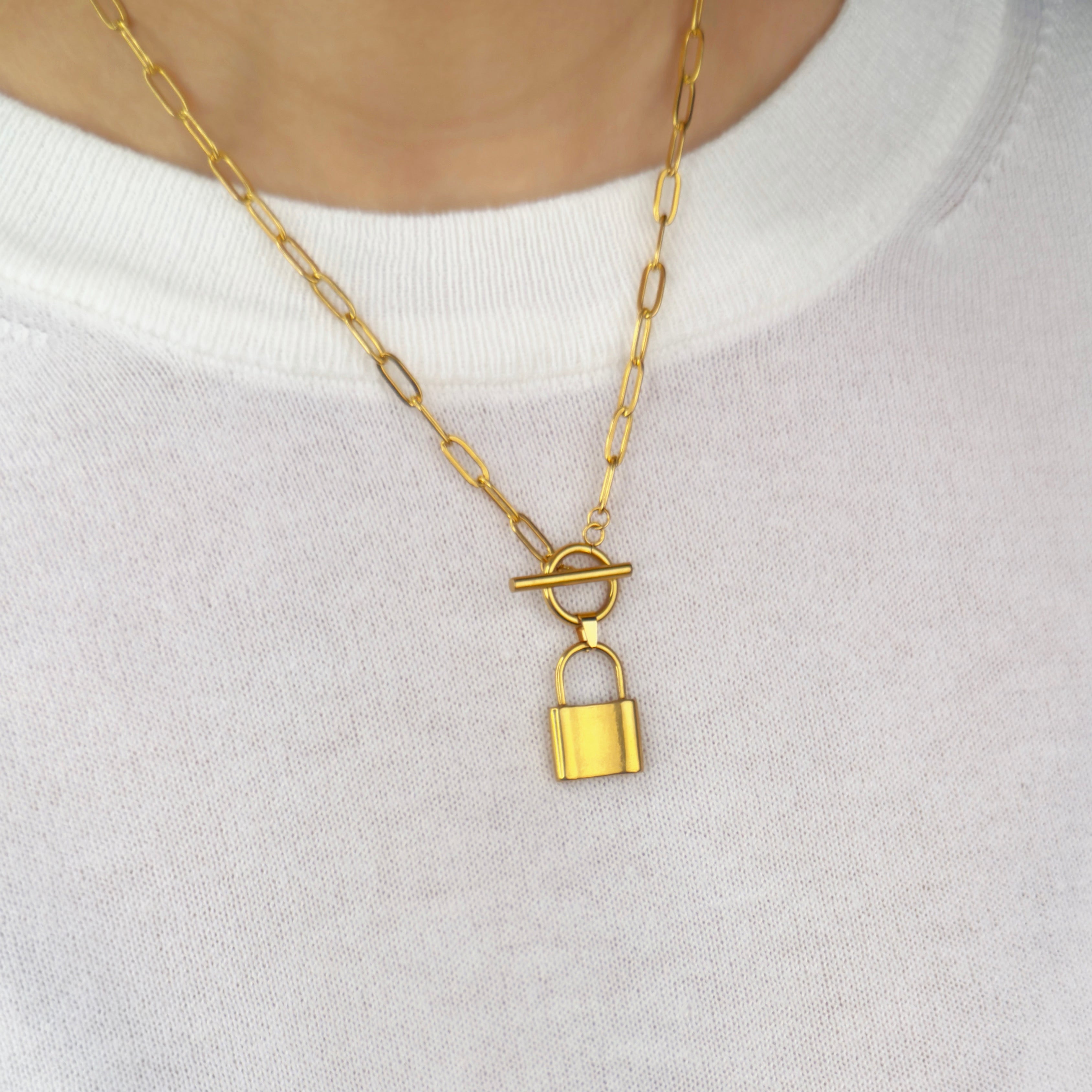 Gold padlock necklace with T bar fastening by Noble Aura UK. Comes in Premium packaging. Free Delivery over £50.

