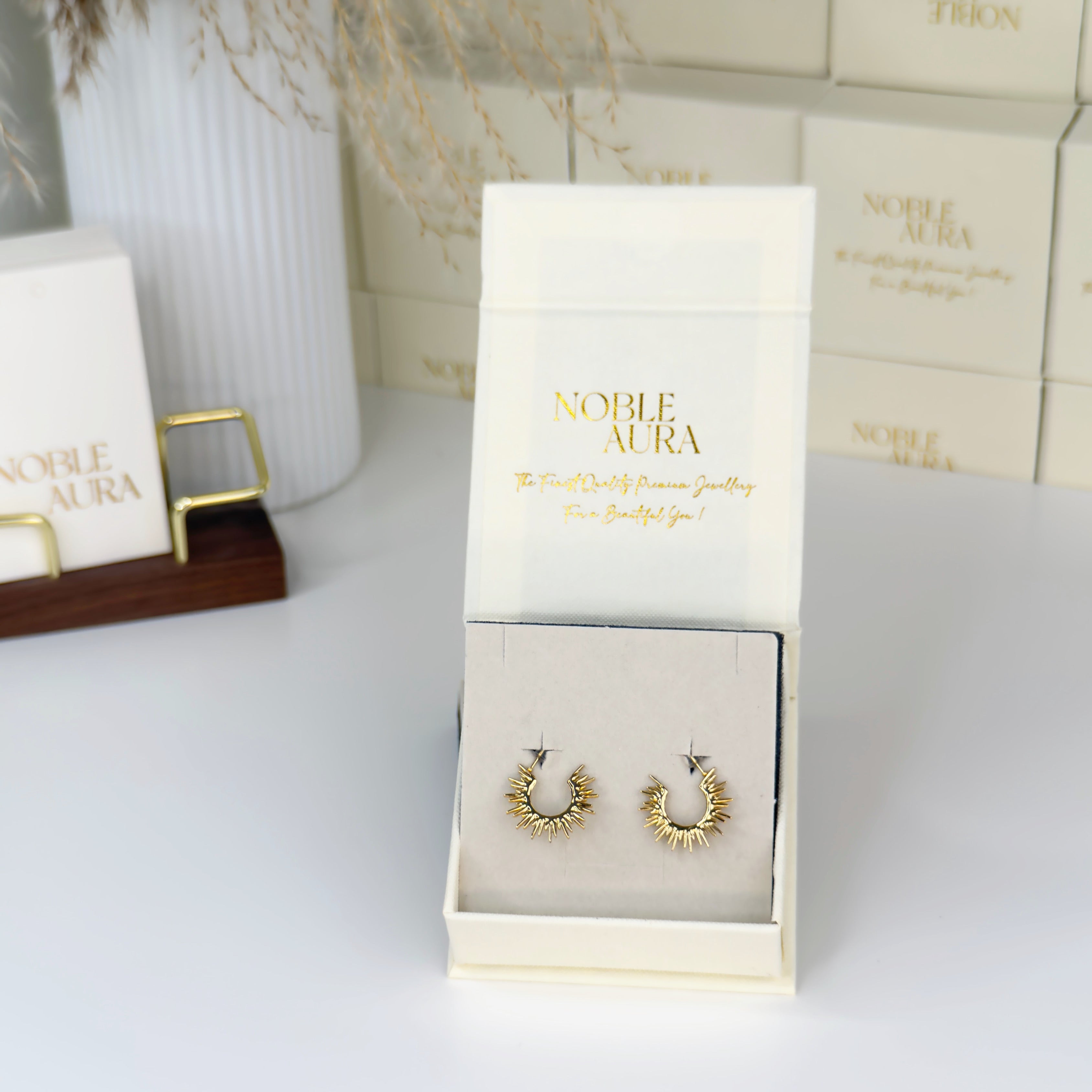 Gold hoop earrings with sunburst detailing by Noble Aura UK