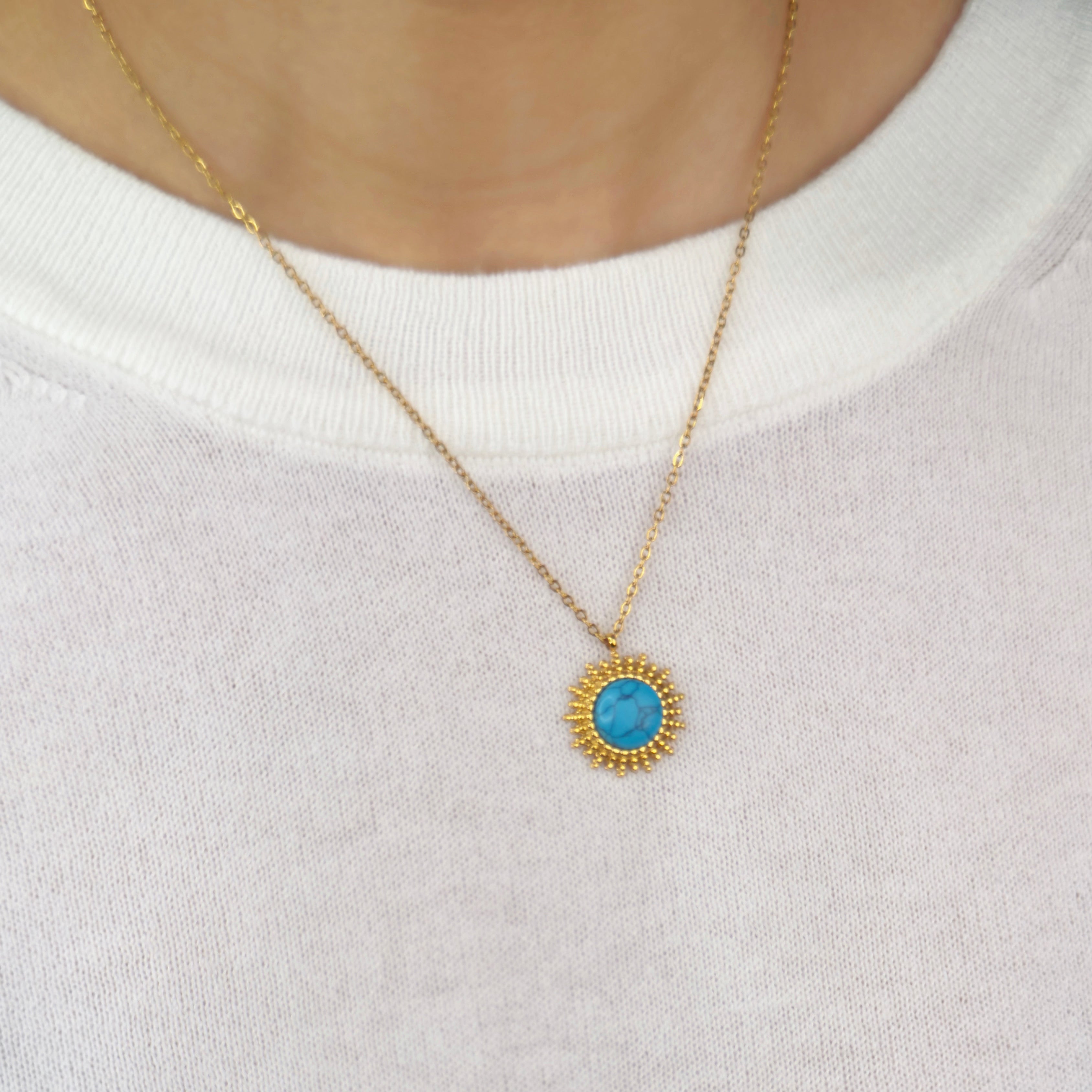 Gold sunburst pendant necklace with turquoise stone centre by Noble Aura UK

