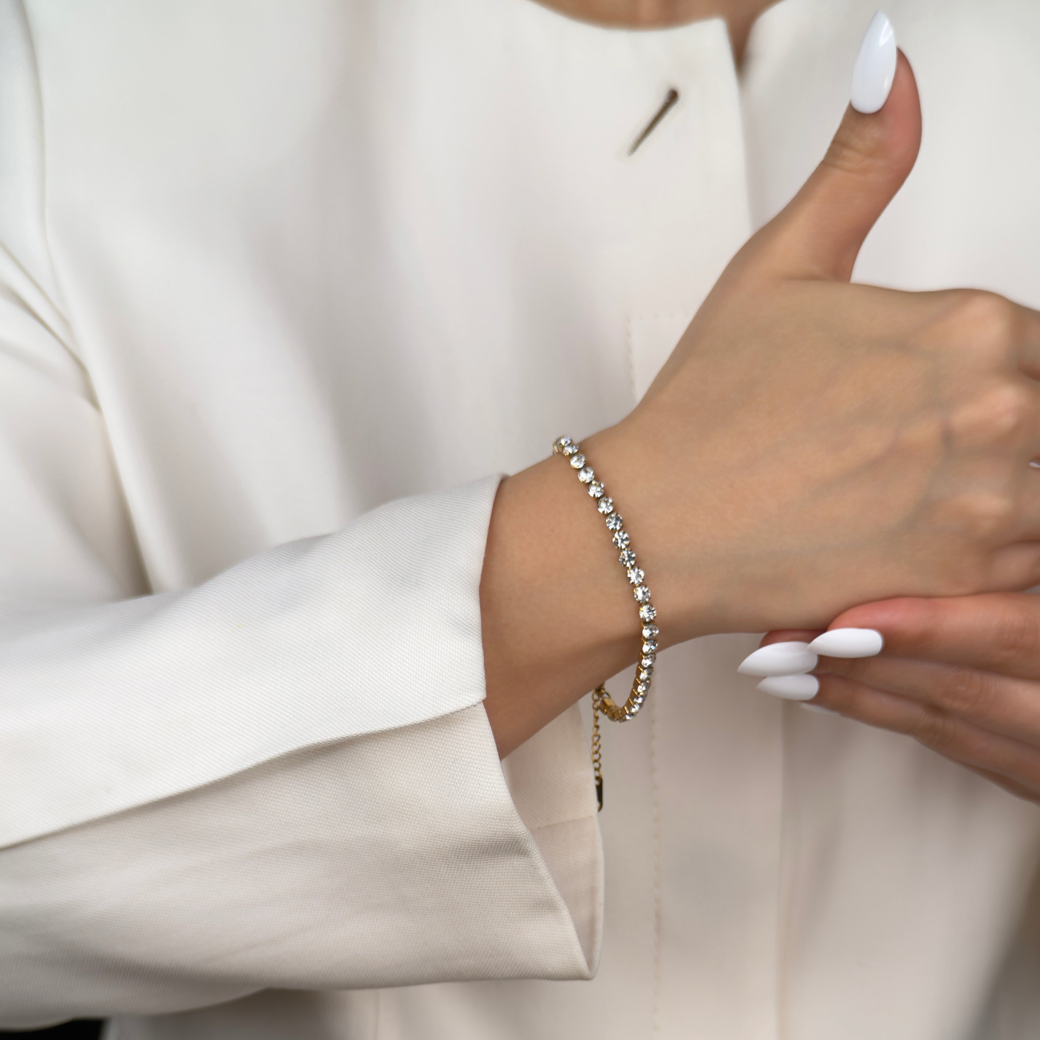 Minimalist gold tennis bracelet with sparkling stones by Noble Aura UK