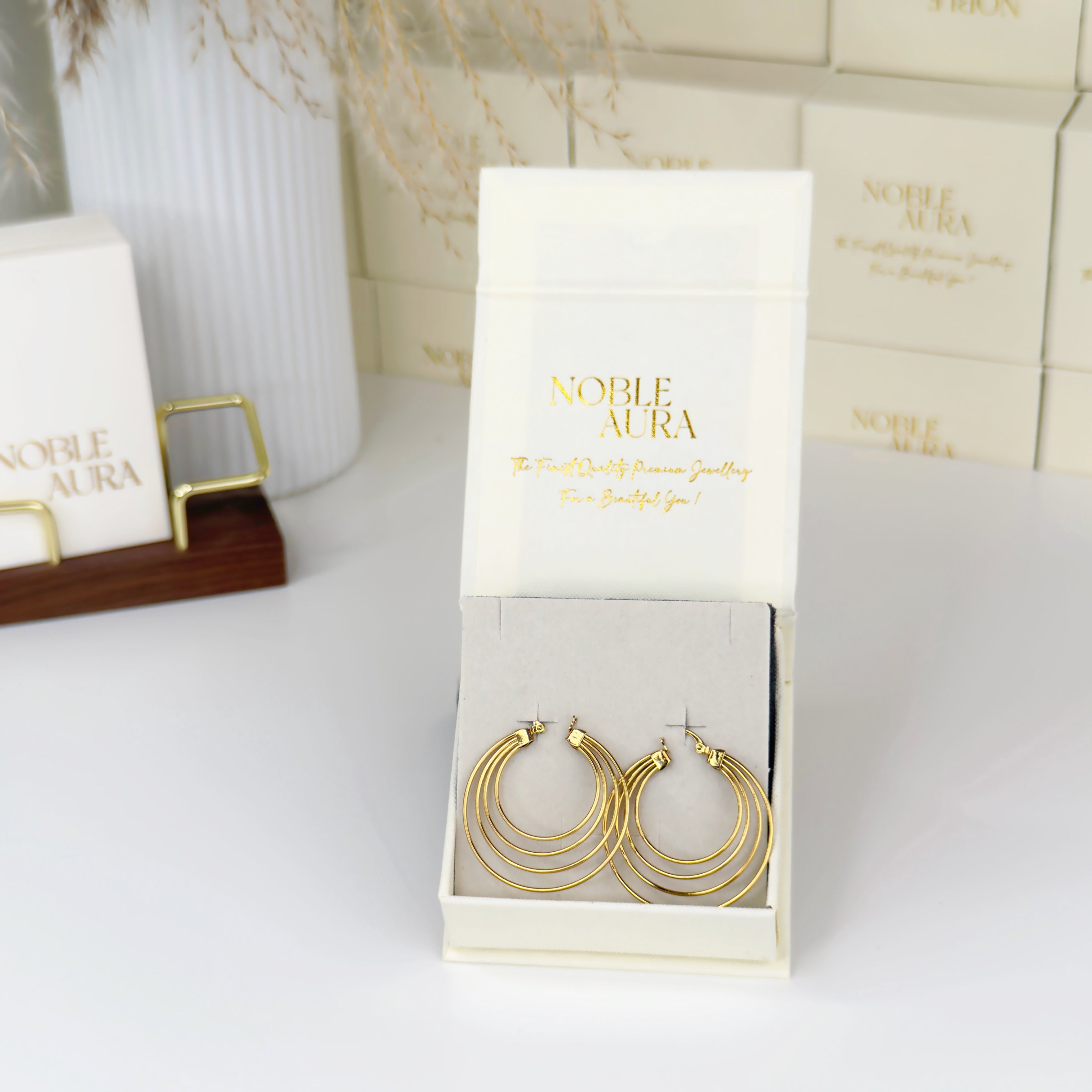 Layered gold hoop earrings with modern stacked design by Noble Aura UK