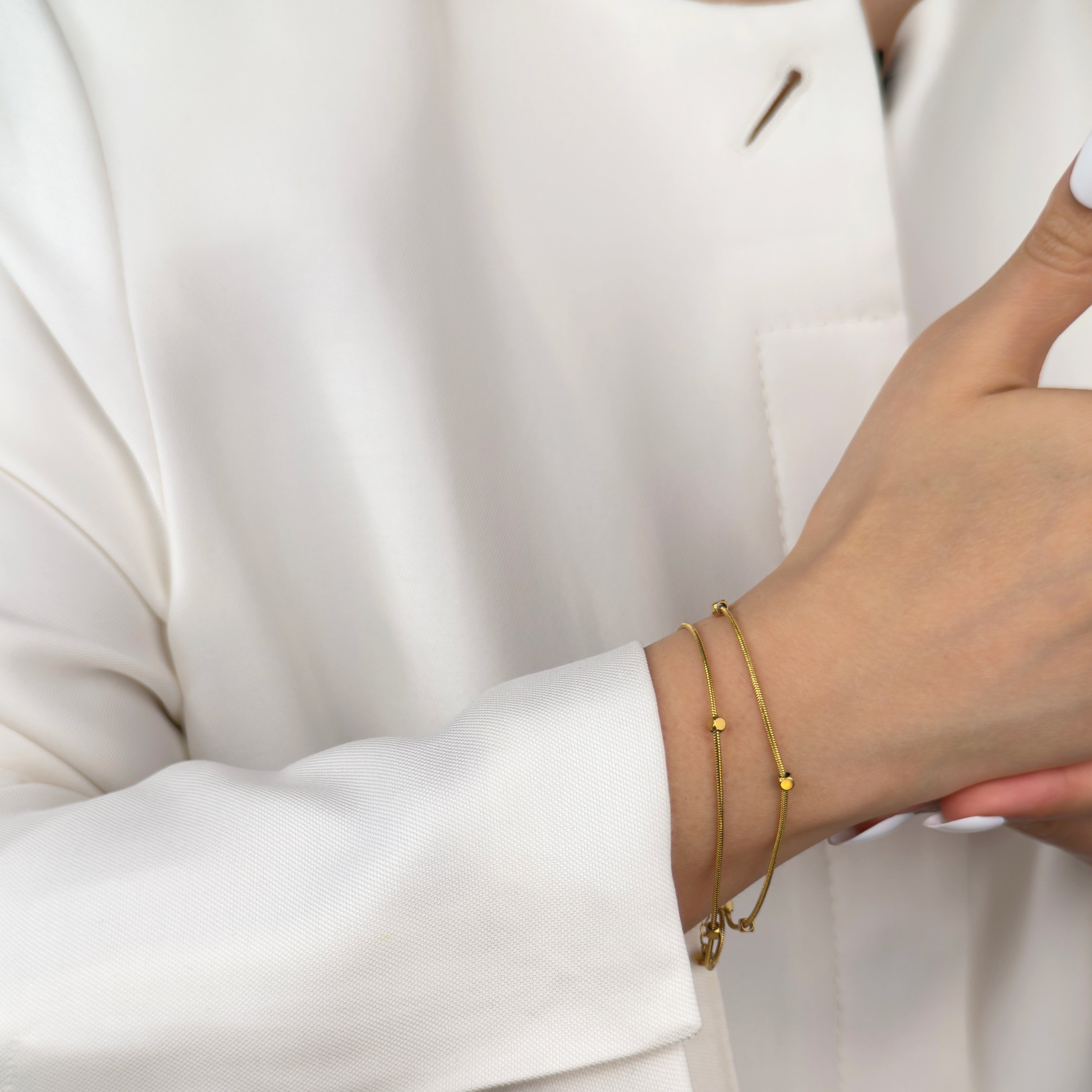 Minimalist gold snake chain bracelet for layering by Noble Aura Jewellery London, UK