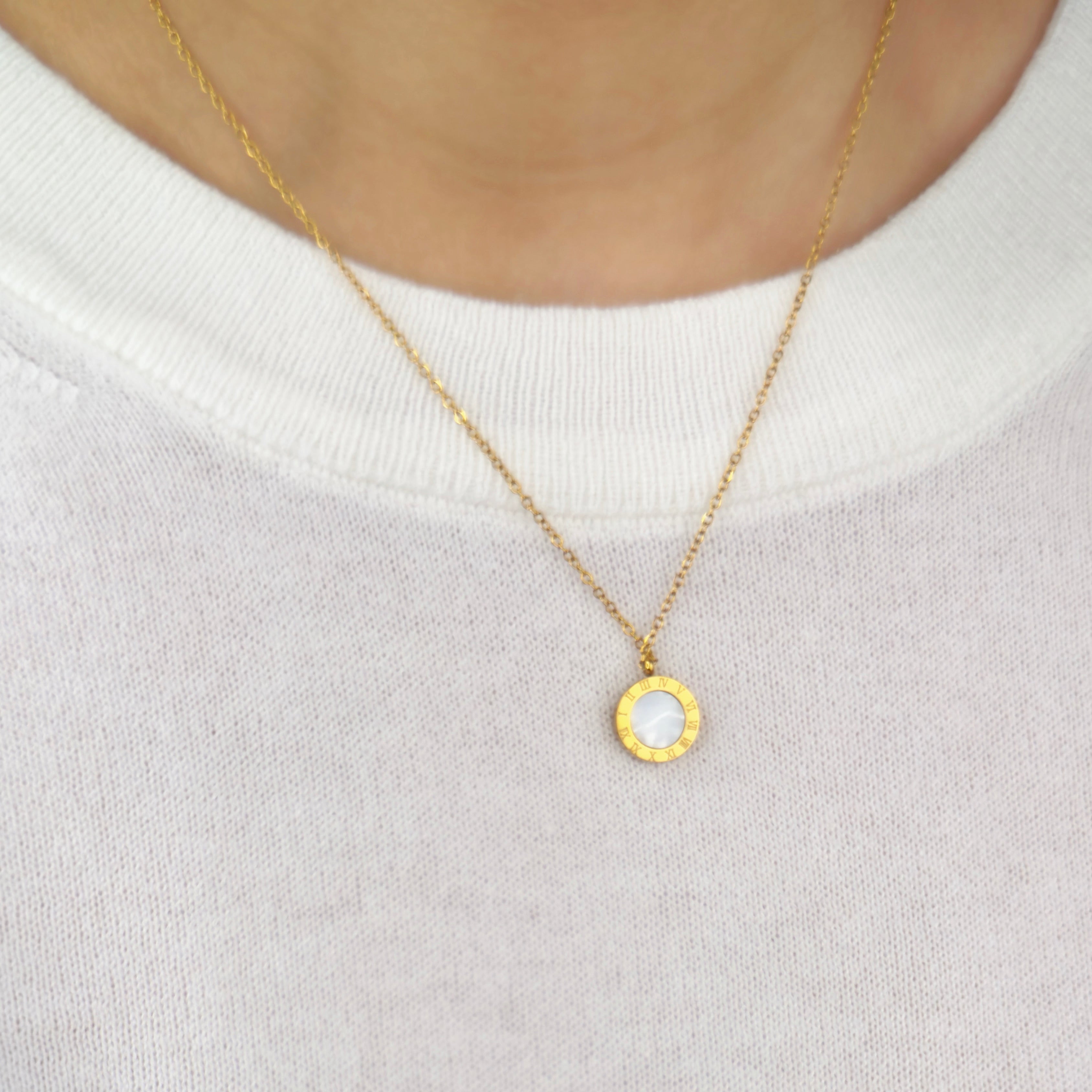 Gold Roman numeral pendant necklace with elegant detailing by Noble Aura UK. Comes in Premium packaging. Free Delivery over £50.